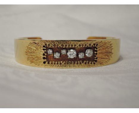 An 18ct gold  cuff bangle designed by Ian Lawrence having a diamond set stylised panel, approx 0.7ct total,  approx 28g