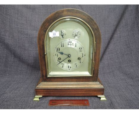 An early 20th century mahogany frame mantel clock having arch case and silvered dial with subsidiary dials and striking movem