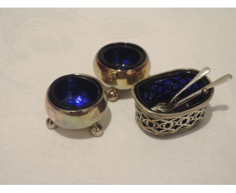 A pair of Edwardian silver salts of plain circular form with blue liners and trefoil bun feet, Chester 1909, Haseler & Bill, 
