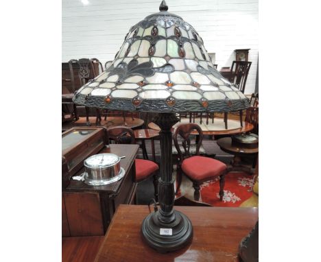 A modern Tiffany style table lamp having hat beaded glass shade on pillar base