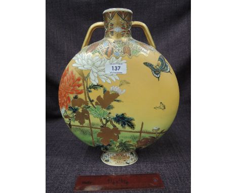 An early 20th century Satsuma pottery moon flask having gilt heightened naturalistic decoration on mustard ground, marked to 