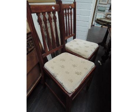 A set of six (4+2) early 20th century oak dining chairs having arrow slat backs with later seats, on shaped legs