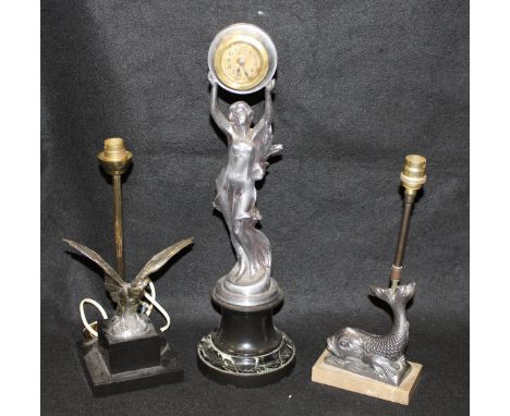 A spelter lamp base in the form of a fish, together with a brass lamp base in the form of an eagle with spread wings, raised 