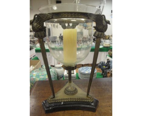 A Louis XV style brass candle holder with clear glass bowl, the three columns surmounted with swans with spread wings and rec