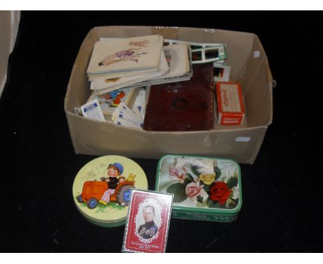 A box containing various playing cards, Brooke Bond tea cards, postcards and an oval plated tray etc.