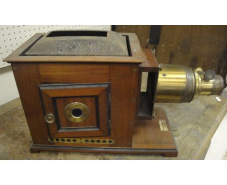 A mahogany and painted tin magic lantern projector by Perken, Son & Rayment of London, with a brass lens marked "Optimus"