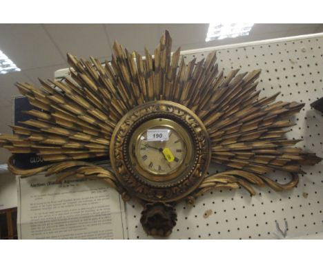 A Smith's wall clock with Roman numerals to the dial set in a carved giltwood starburst frame, together with a further modern