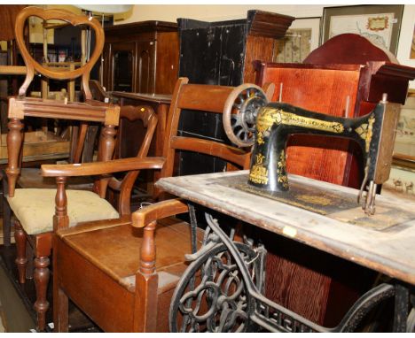 A Singer sewing machine on cast iron treddle base together with a 19th century oak box seat commode chair, a pair of Victoria