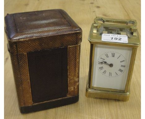 A circa 1900 French lacquered glass cased carriage clock with visible escapement, the dial with Roman numerals raised on brac