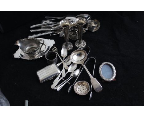 A collection of small silver wares to include a pair of fluted vases, two pairs of sugar tongs, sauce ladle, cigarette case, 