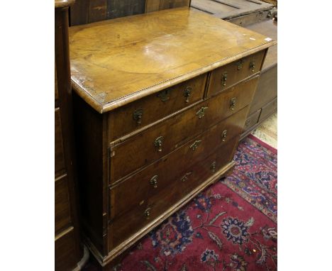A walnut chest in the early 18th Century manner, the quartered top cross banded and with applied moulded edge above two short