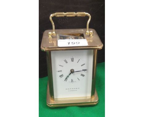A modern brass cased carriage clock, the movement by Matthew Norman of Switzerland, No'd. 1754, the white enamel dial with Ro