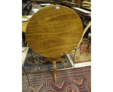 An oak tea table in the 18th Century manner, the circular snap top on a turned pedestal to cabriole tripod base