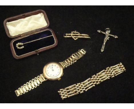 A 9 carat gold gate link bracelet, a 9 carat gold brooch as a bamboo love heart, a 9 carat gold cased ladies wristwatch with 