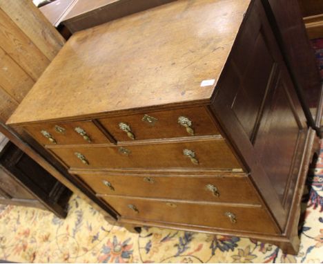 An 18th Century oak chest with a Cavetto moulded top, in two halves of two short over three long graduated drawers with brass