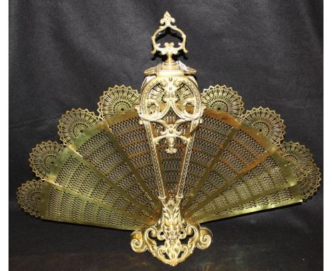 A circa 1900 brass folding "Peacock" firescreen in the French Rococo taste