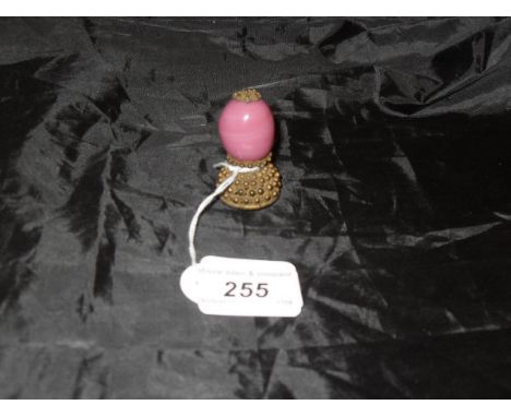 A Chinese mandarin hat finial with brass filigree work and pink glass bead of egg form to simulate pink agate   CONDITION REP