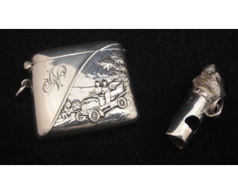 An Edwardian silver dog's head whistle (Birmingham 1902) and an Edwardian silver vesta case decorated in relief with a couple