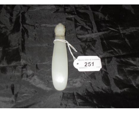 A Chinese jade belt hook with mythical beast mask decoration to the plain main body   CONDITION REPORTS  Basically in sound c