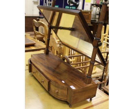 A 19th Century mahogany toilet mirror, the rectangular plate on turned and ringed supports to the bow fronted three drawer ba