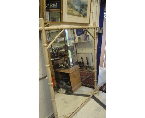 A rectangular wall mirror in a bamboo effect frame