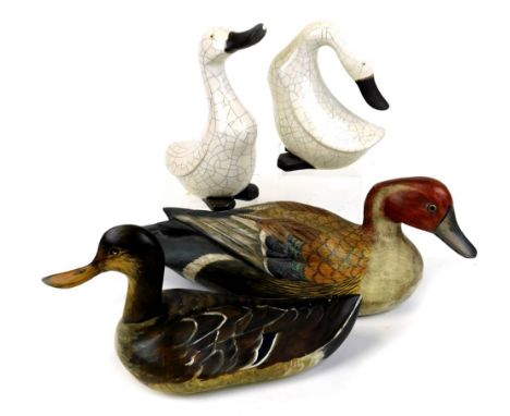 A Baja Indonesian painted decoy style duck, 40cm wide, another signed M Mackie' 86, two pottery duck ornaments. (4)