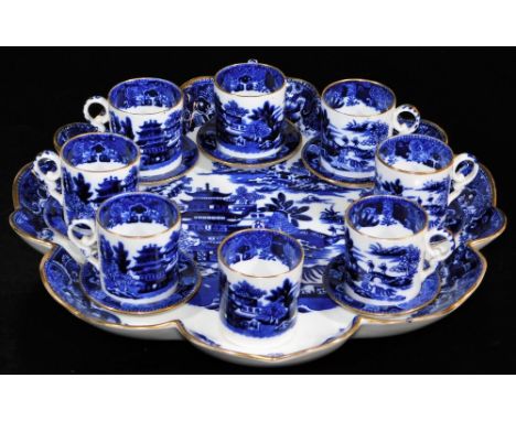 A miniature Copeland blue and white service, comprising coffee cans and seven saucers, on a shaped stand, marks beneath, 28cm