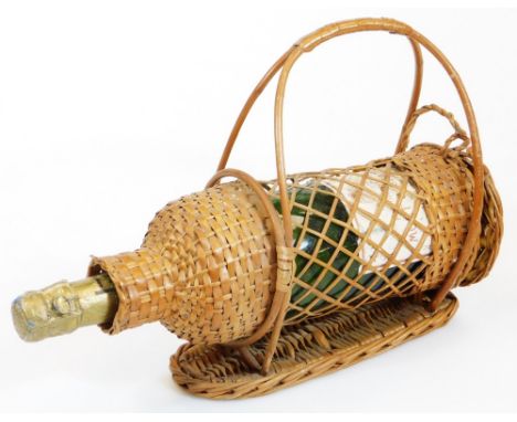 A Vintage bottle of Moet and Chandon champagne, in a wicker carafe, 89cm high. 