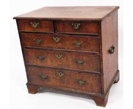 A George III style walnut chest, of two short and three long graduated cock beaded drawers, each with plate back swan handles