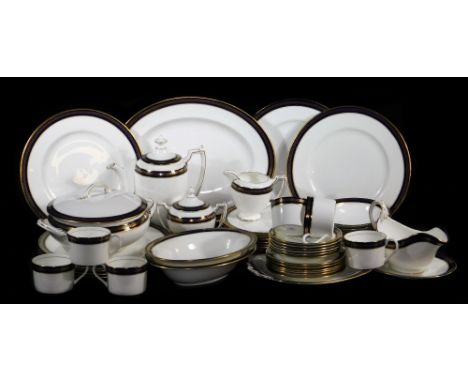 A Coalport dinner service, in royal blue with gilt highlights on a white ground, to include oval meat plate, 37cm wide, servi