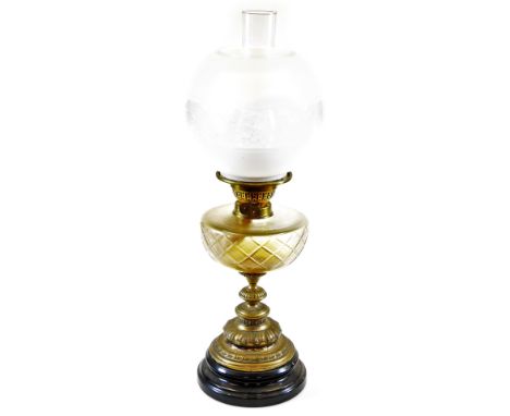 An early 20thC oil lamp, with frosted and clear glass shade, shaped glass reservoir, turned stem and domed foot with plain fu