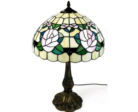 A late 20thC Tiffany style table lamp, with a floral shade, on turned stem and floral metal base, 68cm high.