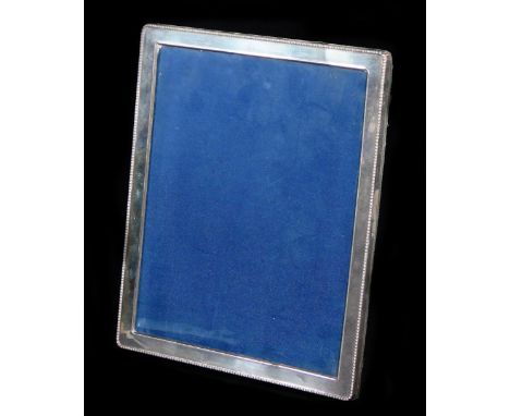 An Elizabeth II silver photograph frame, of oblong form with a bead outline, plain interior and material easel back, Sheffiel