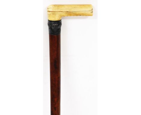 An early 20thC walking stick, with silver collar and cylindrical stem, marks rubbed, 86cm high.