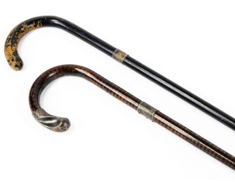 A tiger wood walking cane, with silver collar and end and a further ebonised walking stick with silver collar with metal tip,