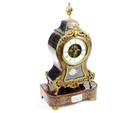 A 19thC Louis XIV style French Boulle mantel clock on stand, the shaped case surmounted by a flame finial, with pierced styli