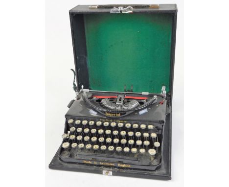 A vintage Imperial typewriter, in black trim, with pressed case, 14cm high.
