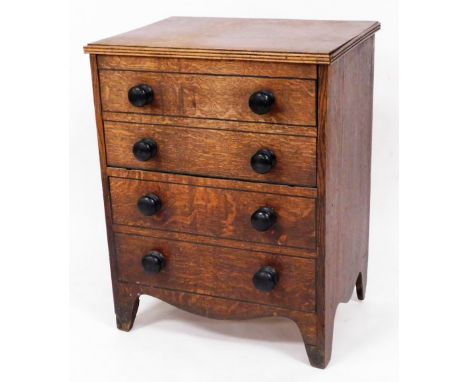 An early 19thC oak commode chest, 58cm wide.