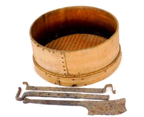 An antique cast iron meat cleaver, two metal mounts and a wooden vintage beekeepers honey divider, 61cm diameter. (a quantity