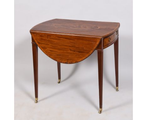 A Regency figured mahogany twin flap oval Pembroke type table, the table top with an oval central panel within crossbanded an