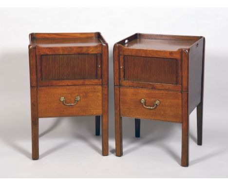 A pair of George III mahogany bedside commode cabinets with galleried tray tops and carrying handles over a tambour fronted c
