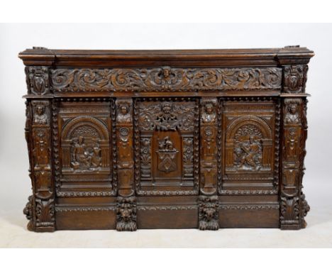 A 19c oak double bedstead, the bedhead with material upholstered panel within profusely carved supports under a carved moulde