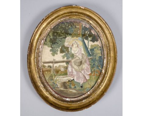A late Georgian silkwork panel depicting a lady fishing in a stream, oval framed and glazed, 9.5in x 7.5in.