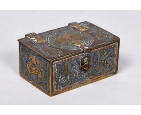 A 19c Anglo Indian brass casket of small proportion with script to front panel decorated with white metal copper scroll and l