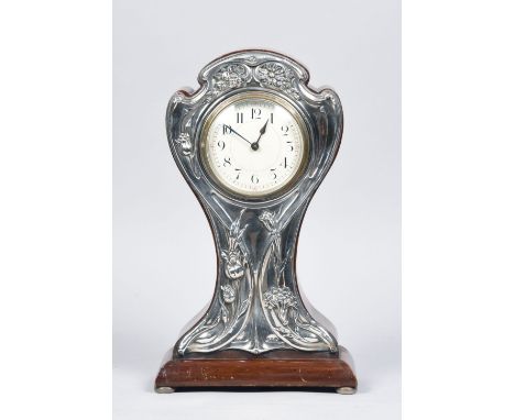 An early 20c French mantel clock, the balloon shaped Art Nouveau case having a silver front panel embossed with foliage and h