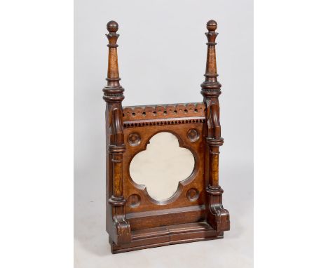 A 19c oak and walnut wall mirror, the quatrefoil mirror plate within a carved and decorated panel, flanked by  turned and car