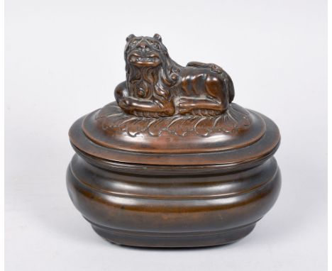 A William IV copper tea caddy of bombe form, the hinged cover with recumbent lion finial, 6.75in w.
