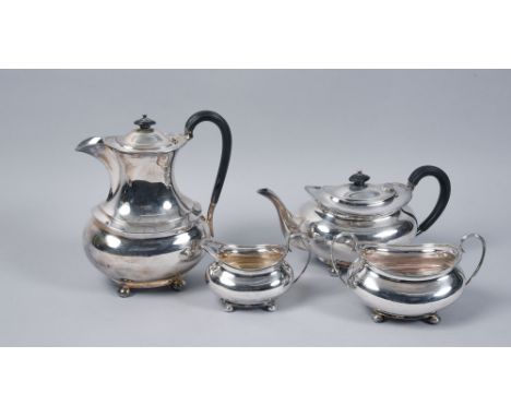 A George V four piece silver service comprising a teapot, 10.75in w, a coffee pot, 9in h, together with two handled sucrier a