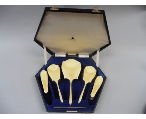 A boxed set of yellow enamel backed and silver brushes and a comb , markers mark for Daniel; Manufacturing Co, Birmingham 193