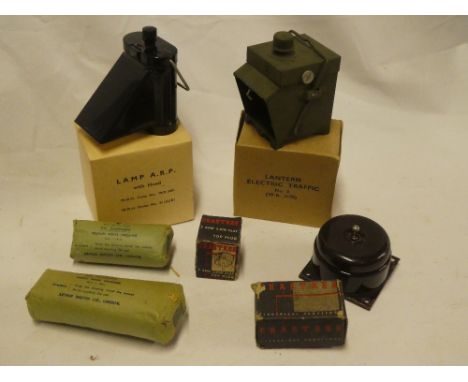 An unissued Second War ARP bicycle lamp with hood in original box, electric traffic lantern in original box; two field dressi